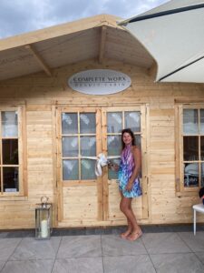 Woman outside timber cabin